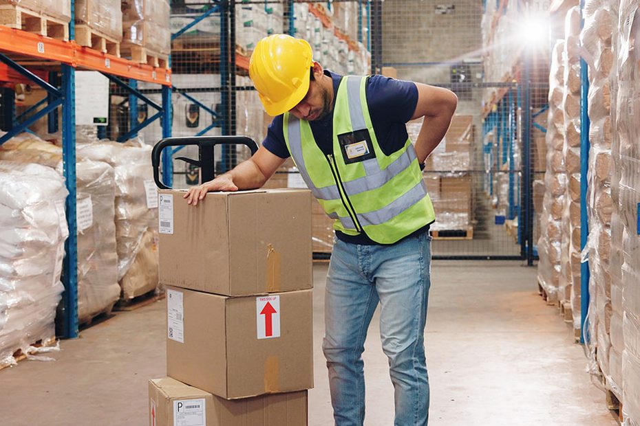 Warehouse worker carrying boxes