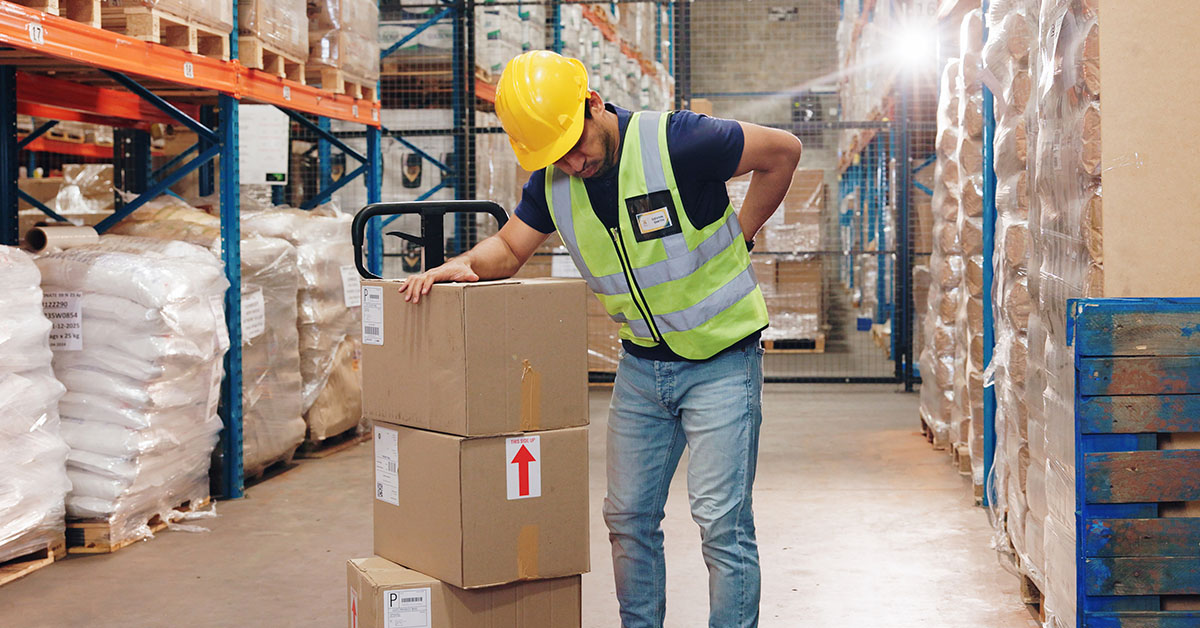 Warehouse worker carrying boxes