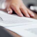 Person signing a legal document