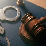 Handcuffs and a judge's gavel